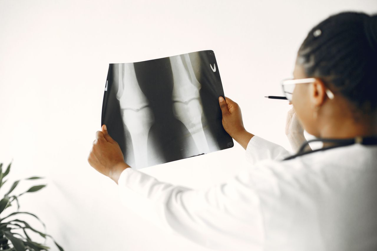 Crafting Captivating Headlines: Your awesome post title goes here A doctor closely examining a patient's knee X-ray for orthopedic evaluation.